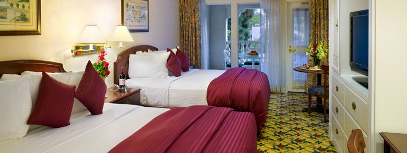 Two beds with a garden entrance looking luxurious